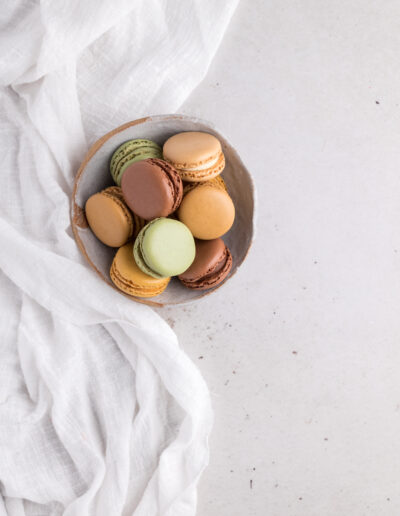 Neutral coloured macarons in a bowl