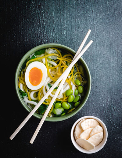 Noodles in bowl on a green background