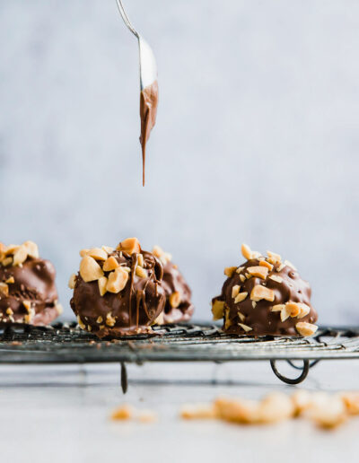 Dripping chocolate on nut truffles
